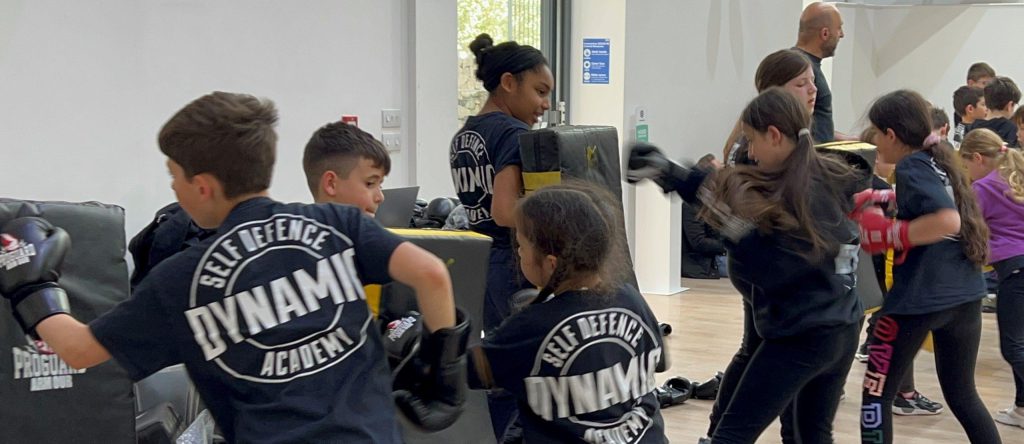 A group of young people taking part in sparring, during a self-defence class.